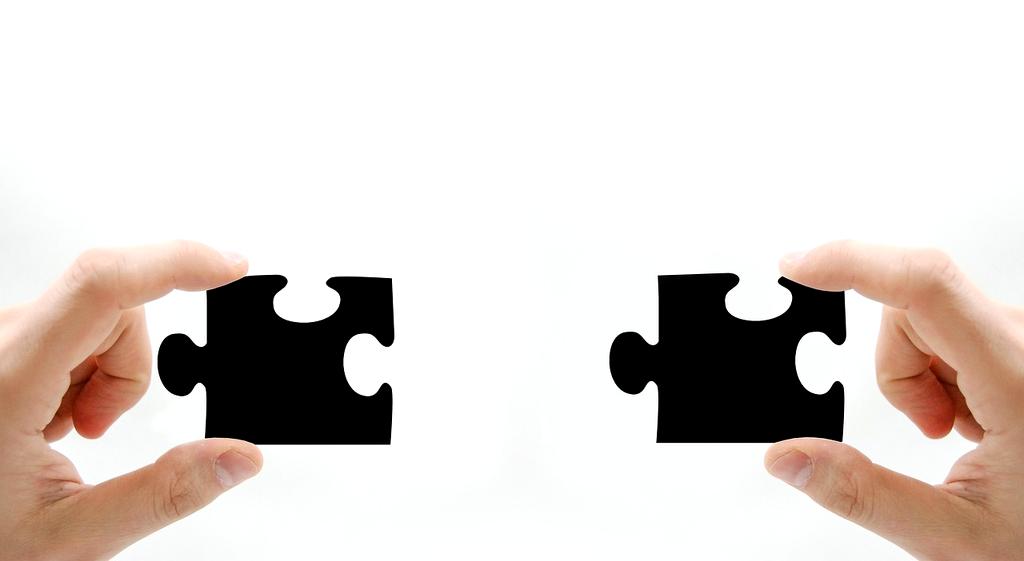 Team collaborating with multiple smart devices displaying automation dashboards