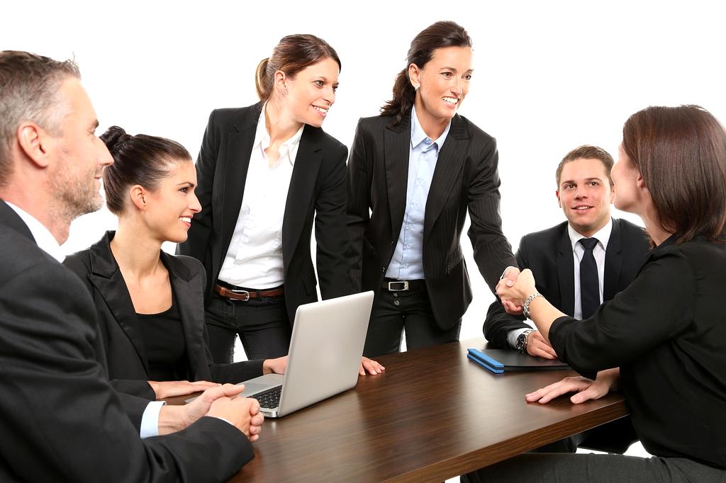 Professional team celebrating productivity improvements in modern office environment